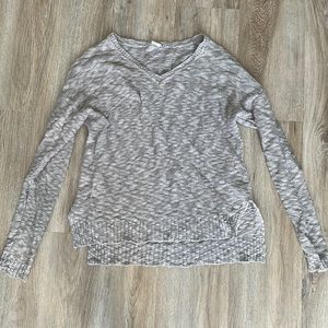 Light oatmeal colored sweater slightly longer in back than front